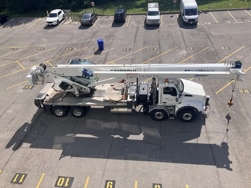 Telescopic boom truck crane parked with outriggers